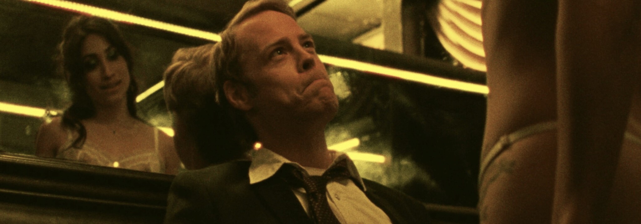 Still from "F*cktoys"; a man looks up at a woman while she stands over him.